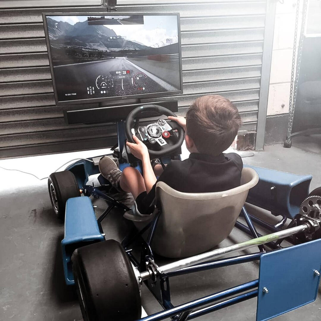 Child on go kart simulator